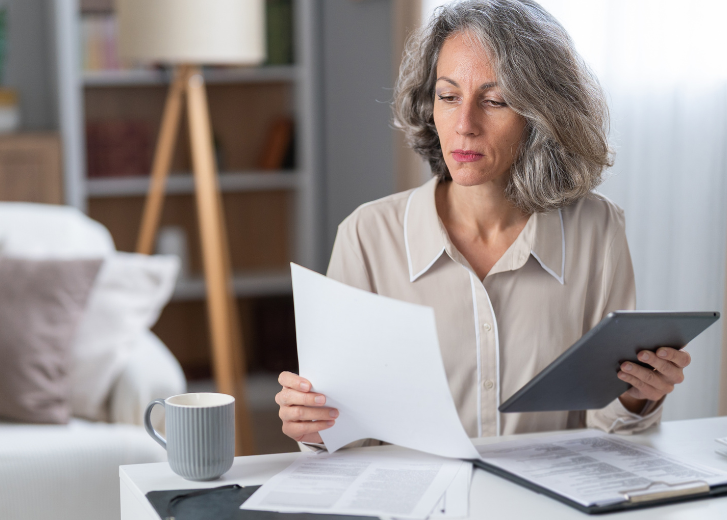Woman looking through retirement strategy paperwork
